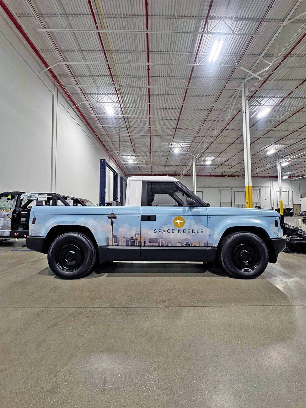 Slate Auto Pickup Truck Wrapped Orange Slate SUV and Pickup (with white roofs) inside Slate's pre-production facility Wrapped Slate pickup white roof 1