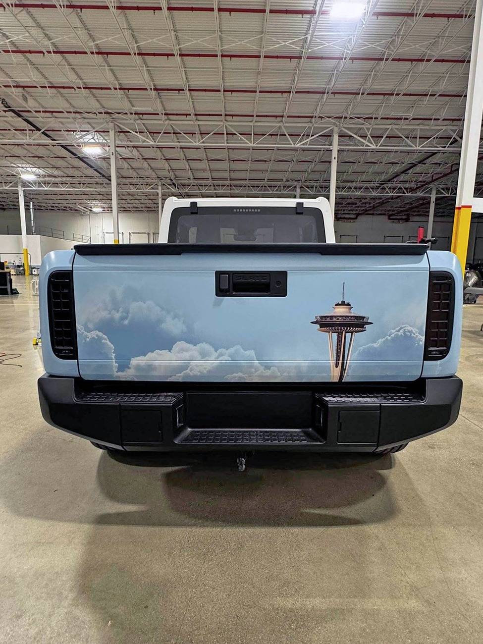 Slate Auto Pickup Truck Wrapped Orange Slate SUV and Pickup (with white roofs) inside Slate's pre-production facility Wrapped Slate pickup white roof 2