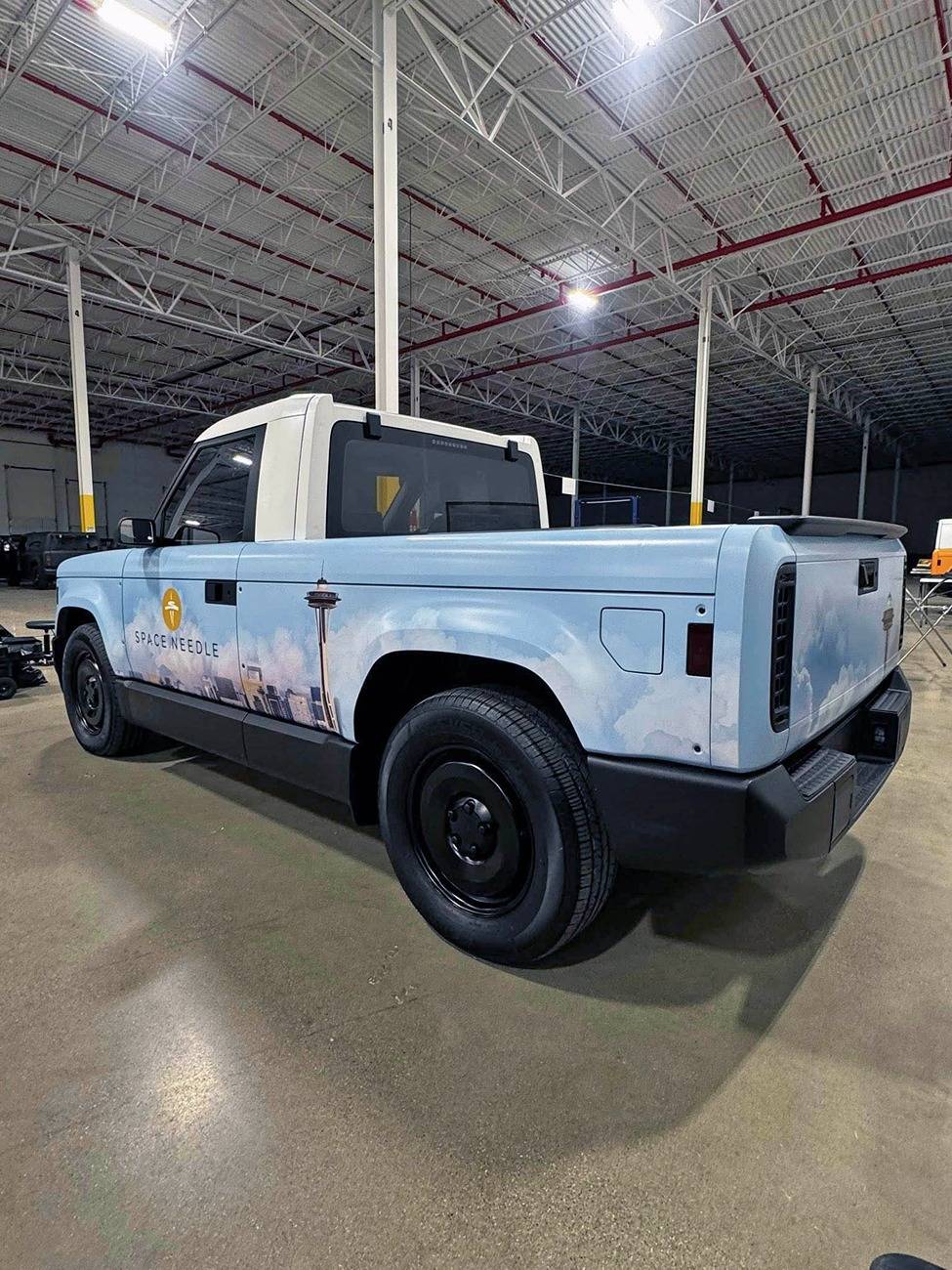 Slate Auto Pickup Truck Wrapped Orange Slate SUV and Pickup (with white roofs) inside Slate's pre-production facility Wrapped Slate pickup white roof 3